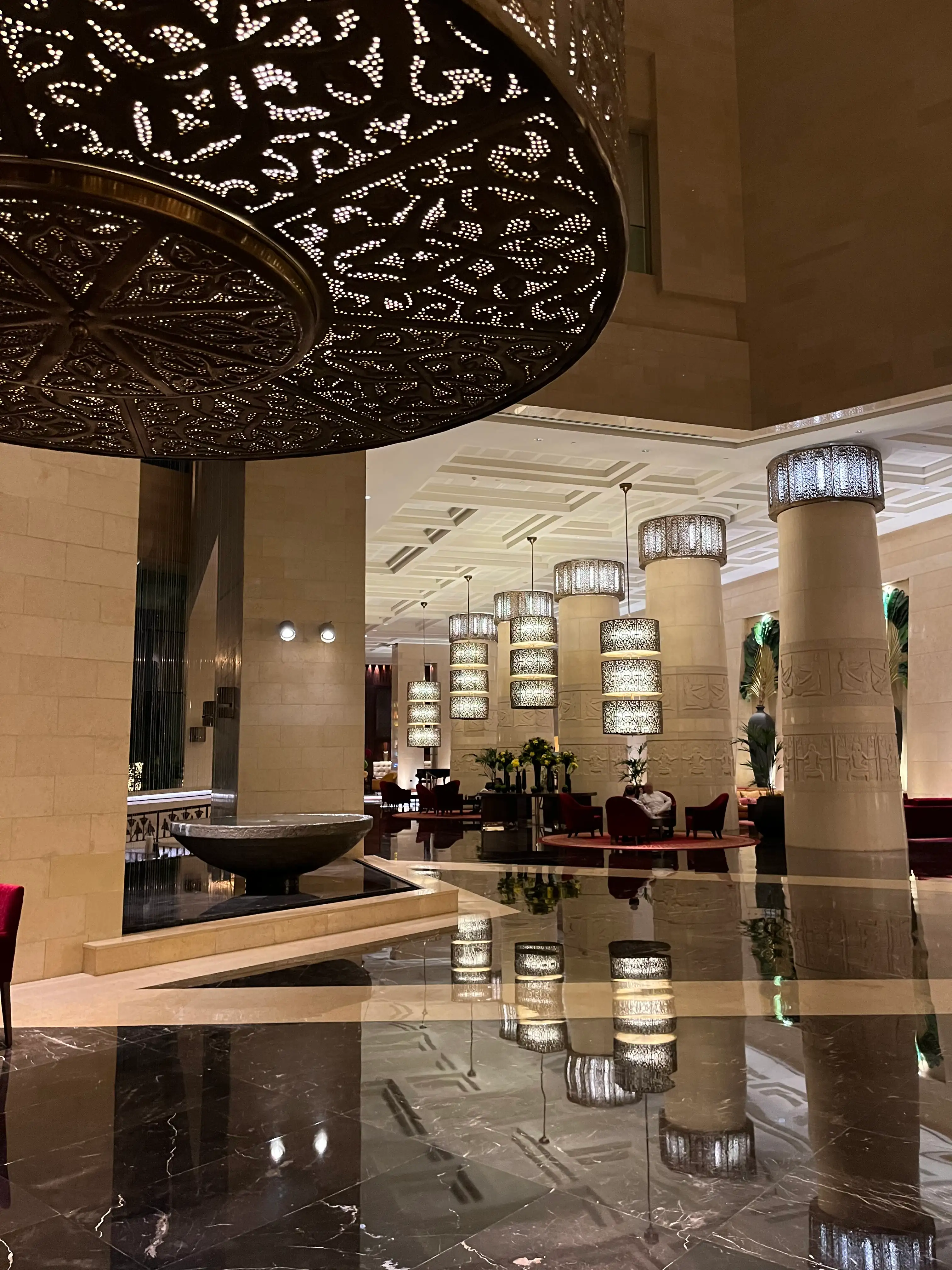 Raffles Dubai luxury hotel interior featuring iconic pyramid architecture, opulent Arabian-inspired design, contemporary Asian elegance, designer lighting, marble finishes, and exclusive five-star hospitality in Dubai. A sophisticated destination for luxury fashion travellers, affluent clientele, business elites, and high-end lifestyle enthusiasts seeking premium suites, luxury spa experiences, fine dining, and refined Middle Eastern glamour.